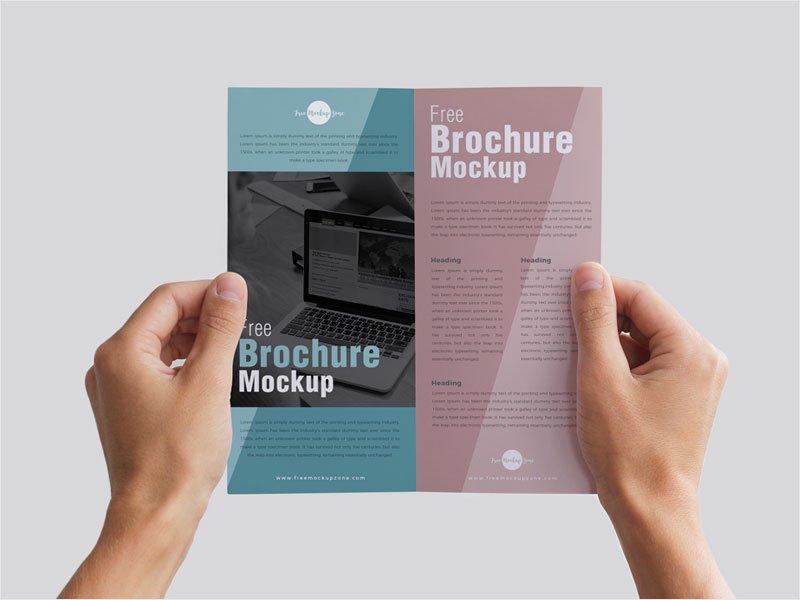 Free-Man-Holding-Brochure-in-Hands-Mockup-PSD