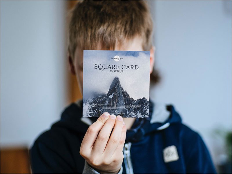 Free-Little-Boy-Showing-Square-Card-Mockup-PSD